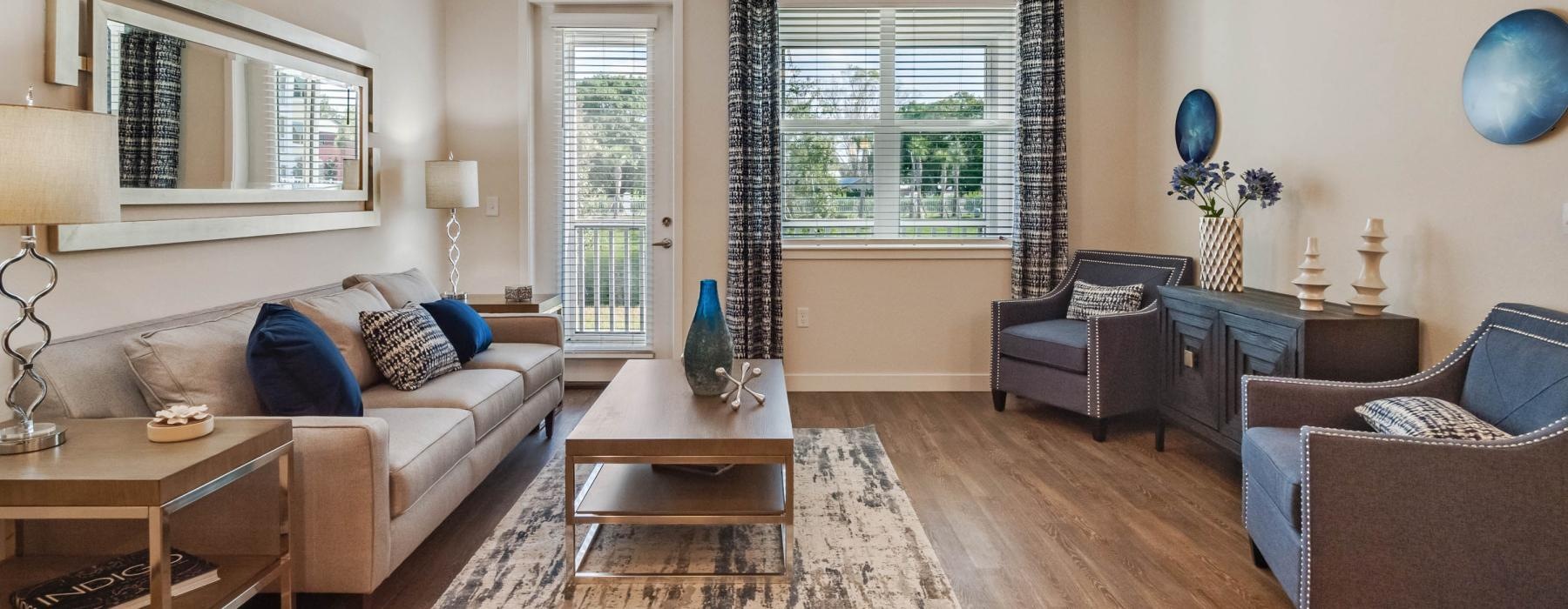 a living room with a fan and a large window