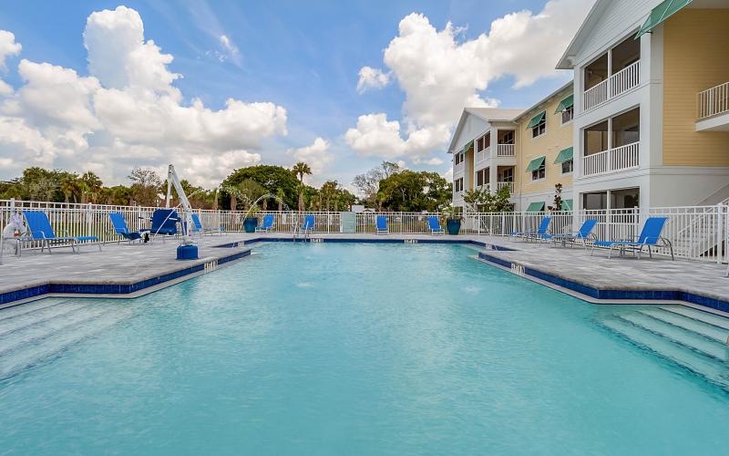a swimming pool with a building in the background