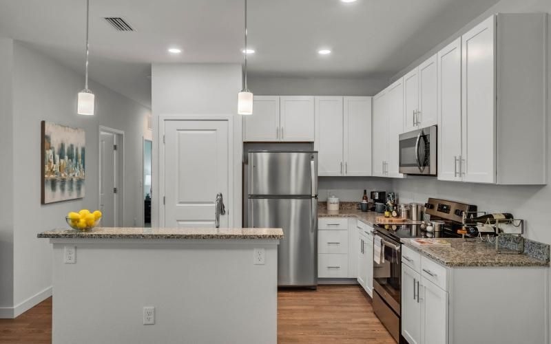 a kitchen with white cabinets